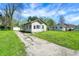 Quaint home with a long driveway, detached garage, and a spacious yard, offering comfortable living at 4941 Mathews Ave, Indianapolis, IN 46227