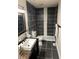 Modern bathroom featuring a sleek vanity, black tile shower, and stylish fixtures at 4984 W 59Th St, Indianapolis, IN 46254