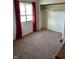 Bedroom features a window with red curtains and a standard closet at 4984 W 59Th St, Indianapolis, IN 46254
