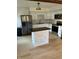 Bright kitchen with white cabinets, stainless steel appliances, island, and hardwood floors providing ample space at 4984 W 59Th St, Indianapolis, IN 46254