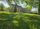 Spacious backyard with mature trees surrounding the house and property at 5103 W Vermont St, Indianapolis, IN 46224