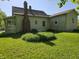 Expansive backyard and home showcasing mature trees and vinyl siding at 5103 W Vermont St, Indianapolis, IN 46224