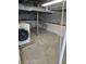 Unfinished basement with washer, block foundation, and cement floor at 5103 W Vermont St, Indianapolis, IN 46224