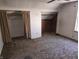 Attic bedroom featuring tan carpet, white walls, and built in closet with brown curtains at 5103 W Vermont St, Indianapolis, IN 46224