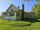 View of the back of the home showing the chimney and vinyl siding at 5103 W Vermont St, Indianapolis, IN 46224
