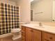 Bathroom featuring a toilet with blue and yellow plaid shower curtain at 515 E Hoover Dr, Nineveh, IN 46164
