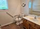 Accessible bathroom with grab bars and wooden vanity at 515 E Hoover Dr, Nineveh, IN 46164