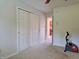 Neutral bedroom featuring a closet with sliding doors and an exercise bike at 515 E Hoover Dr, Nineveh, IN 46164