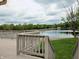 View from the deck overlooking the serene lake, surrounded by mature trees and lush greenery at 515 E Hoover Dr, Nineveh, IN 46164
