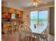 Inviting dining area with wood table set and sliding door access to the outdoor lake-view deck at 515 E Hoover Dr, Nineveh, IN 46164