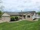 Traditional brick home featuring an attached three-car garage and lakeside deck at 515 E Hoover Dr, Nineveh, IN 46164
