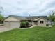 Charming brick ranch-style home with well-manicured lawn and a three-car garage, perfect for lakeside living at 515 E Hoover Dr, Nineveh, IN 46164