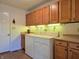 Bright laundry room featuring a washer and dryer, wooden cabinets and a tile floor at 515 E Hoover Dr, Nineveh, IN 46164