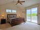 Main bedroom features a private balcony and ceiling fan at 515 E Hoover Dr, Nineveh, IN 46164
