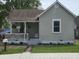 Cozy one-story house featuring a charming porch, flowering plants, and a well-manicured lawn at 533 W Pike St, Martinsville, IN 46151