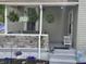 Inviting front porch with stone accents, hanging flower baskets, and a quaint seating area at 533 W Pike St, Martinsville, IN 46151