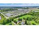 An aerial view displays the community with winding streets, many similar homes, and a lovely pond at 5580 Pintail Ln, Greenwood, IN 46143