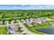 A high-angle view of a residential area featuring attractive homes, lush landscaping, and a tranquil lake at 5580 Pintail Ln, Greenwood, IN 46143