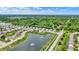 An aerial view shows a well-planned community with a pond, fountains and single Gathering homes at 5580 Pintail Ln, Greenwood, IN 46143