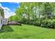 A spacious backyard with lush green grass surrounding a deck area, creating an inviting outdoor space at 5580 Pintail Ln, Greenwood, IN 46143
