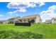 Lush green backyard with deck, ideal for outdoor activities and enjoying nature at 5580 Pintail Ln, Greenwood, IN 46143