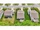 Overhead view showcasing the backyards of residential properties, featuring well-manicured lawns, patios, and outdoor seating areas at 5580 Pintail Ln, Greenwood, IN 46143