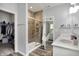 This bathroom includes a glass shower enclosure, a view to the main bedroom, and a double vanity at 5580 Pintail Ln, Greenwood, IN 46143