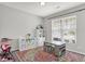 Bright room featuring a playful rug, white shelving, and a art table set by the window at 5580 Pintail Ln, Greenwood, IN 46143