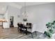 Bright dining room with contemporary lighting, hardwood floors, and open layout at 5580 Pintail Ln, Greenwood, IN 46143