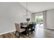 Dining room with modern lighting fixture and sliding glass doors to the outdoor patio at 5580 Pintail Ln, Greenwood, IN 46143