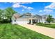 Inviting two-story home with a spacious driveway, lush lawn, and charming front porch at 5580 Pintail Ln, Greenwood, IN 46143