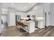 Bright kitchen with white cabinets, stainless steel appliances, and an island with barstool seating at 5580 Pintail Ln, Greenwood, IN 46143