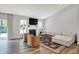 Bright living room featuring a fireplace, large windows, and comfortable seating at 5580 Pintail Ln, Greenwood, IN 46143