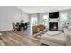 Open-concept living room and dining area featuring hardwood floors and a fireplace at 5580 Pintail Ln, Greenwood, IN 46143