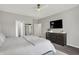 This main bedroom includes a ceiling fan, TV, neutral walls and modern furnishings at 5580 Pintail Ln, Greenwood, IN 46143