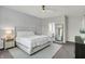This main bedroom boasts a ceiling fan, and an ensuite bathroom with a view from the doorway at 5580 Pintail Ln, Greenwood, IN 46143