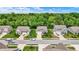 Street-level view of well-maintained homes with manicured lawns and mature trees creating a picturesque neighborhood setting at 5580 Pintail Ln, Greenwood, IN 46143