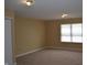 Neutral carpeted bedroom with natural light and blinds on the window at 5708 Outer Bank Rd, Indianapolis, IN 46239