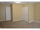 Bedroom with neutral paint, carpet, and white doors at 5708 Outer Bank Rd, Indianapolis, IN 46239