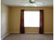 Bedroom with a window and red curtains plus carpeted floors and a ceiling fan at 5708 Outer Bank Rd, Indianapolis, IN 46239