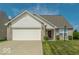 Charming home featuring a two-car garage, brick accents, well-manicured lawn and welcoming front porch at 5708 Outer Bank Rd, Indianapolis, IN 46239
