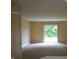 Spacious living room featuring neutral walls, carpet, and sliding glass door to outside at 5708 Outer Bank Rd, Indianapolis, IN 46239