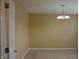 Neutral room featuring tan walls, carpeted floor and silver chandelier at 5708 Outer Bank Rd, Indianapolis, IN 46239