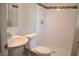 Tiled bathroom features modern fixtures, including a pedestal sink and walk-in shower at 5979 S Walcott St, Indianapolis, IN 46227