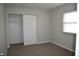 Bedroom features neutral carpet, closet with sliding doors, and window at 5979 S Walcott St, Indianapolis, IN 46227
