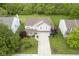 Aerial view of a home with a well-maintained lawn, mature trees, and a spacious driveway at 6270 Lancaster Pl, Zionsville, IN 46077