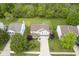 Aerial view of a home nestled among mature trees in a neighborhood setting, showcasing its location at 6270 Lancaster Pl, Zionsville, IN 46077