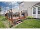 Back deck with chairs and a table, lights, and landscaping at 6270 Lancaster Pl, Zionsville, IN 46077