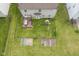 Aerial view of a fenced-in backyard with a deck, playset, and garden plots, perfect for outdoor living at 6270 Lancaster Pl, Zionsville, IN 46077