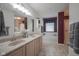 Well-lit bathroom featuring double sinks, a bathtub with tile surround, and a separate shower at 6270 Lancaster Pl, Zionsville, IN 46077